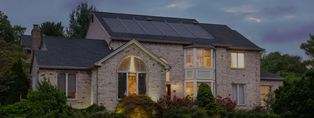Une belle maison en brique avec bardeaux solaires en bois, comment nettoyer les panneaux solaires sur le toit